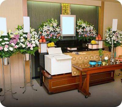 A solemn funeral altar adorned with flowers and offerings.